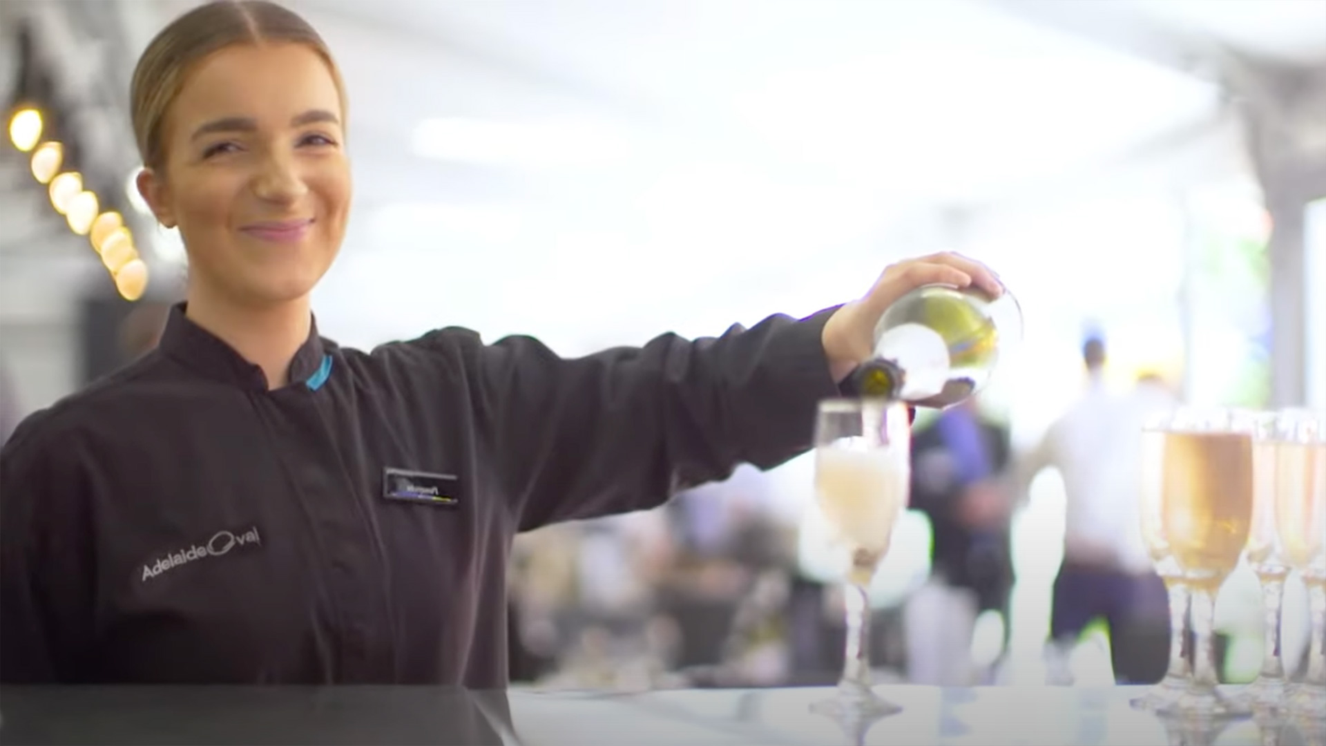 female pouring champagne